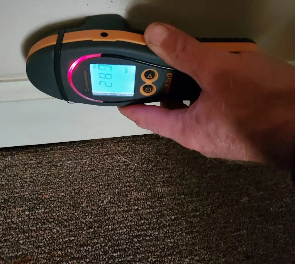 Moisture detection at baseboard during Storm Damage Restoration in Aiea